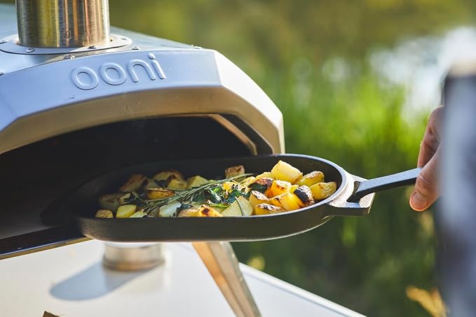 ooni Cast Iron Sizzler Pan - Griddle Frying Pan, 12" x 6" Sizzler Plate with Removable Handle and Stainless Steel Trivet, Pre-Seasoned Non-Stick Oven Safe Cookware, Pizza Oven and BBQ Accessories