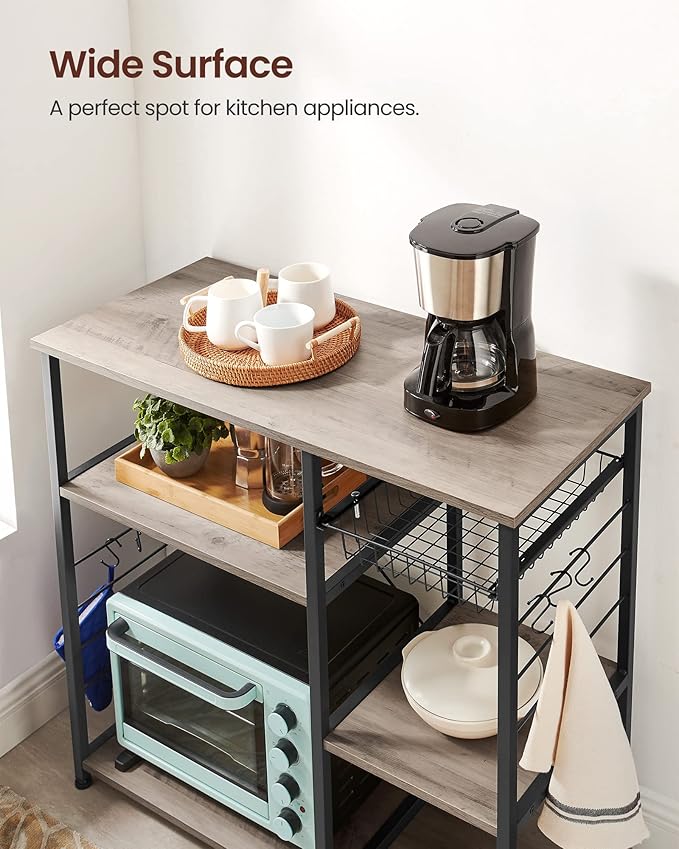 VASAGLE ALINRU Kitchen Baker’s Rack, Coffee Bar, Microwave Oven Stand, with Steel Frame, Wire Basket, 6 Hooks, for Mini Oven, Spices Utensils, Industrial, Heather Greige and Ink Black UKKS090B02